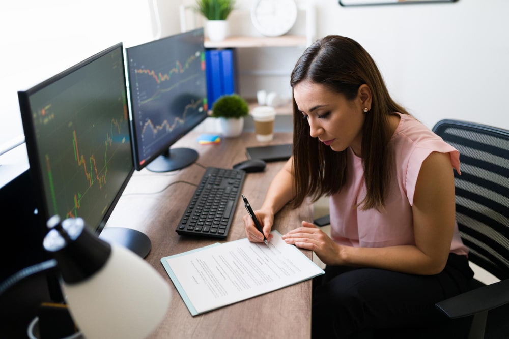 Woman using laptop with coffee